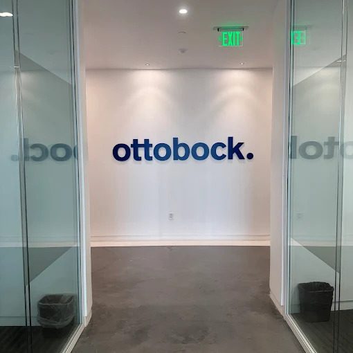Dimensional acrylic letters installed on an office lobby wall.