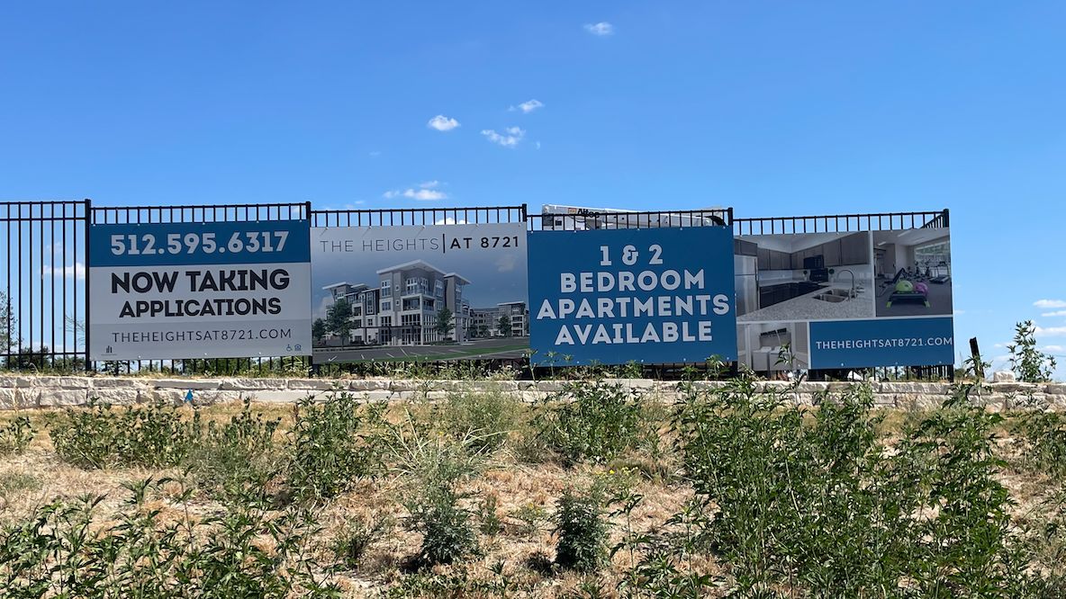 Apartment leasing fence signs promoting available units at The Heights at 8721