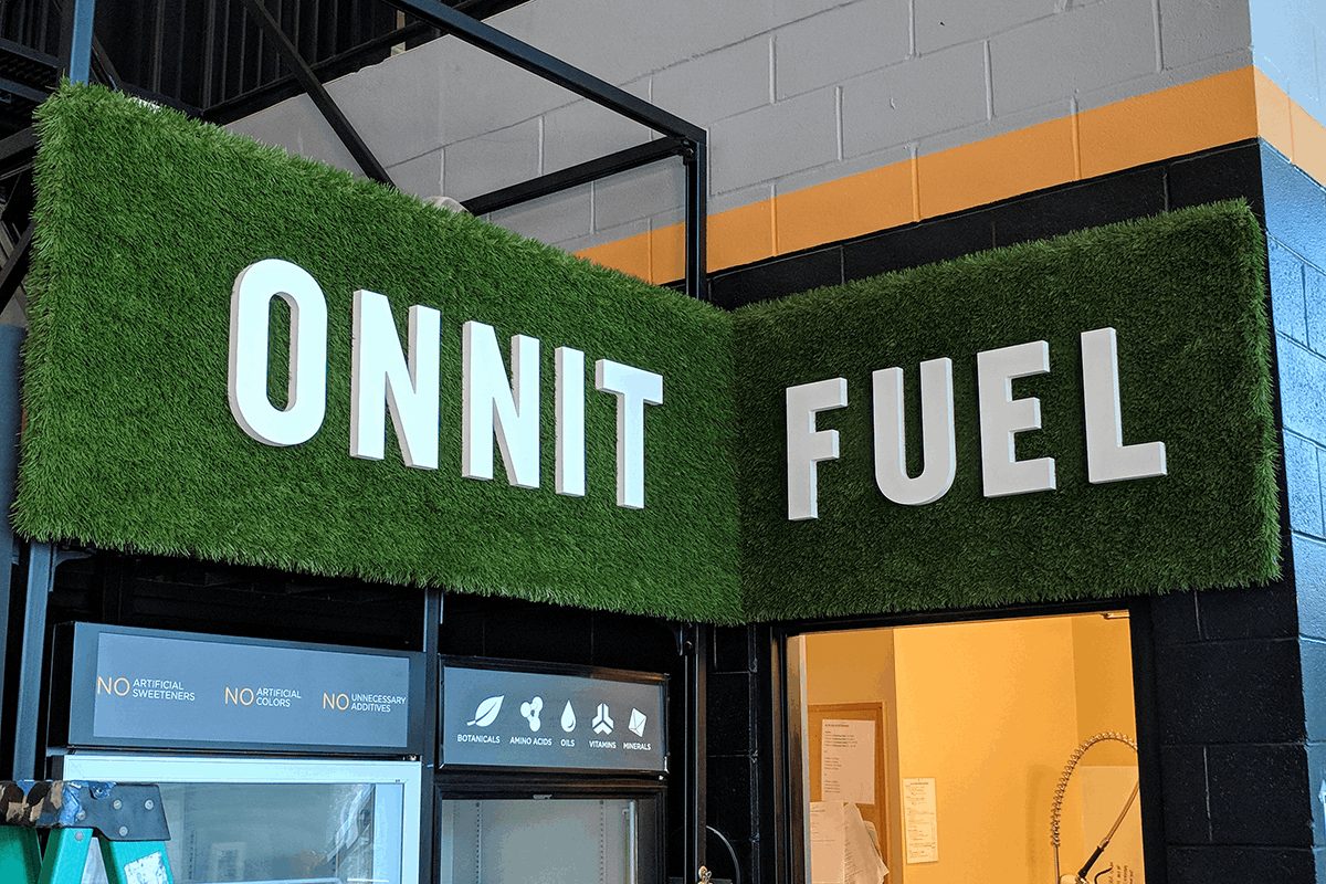 Dimensional letters mounted to a green wall sign.